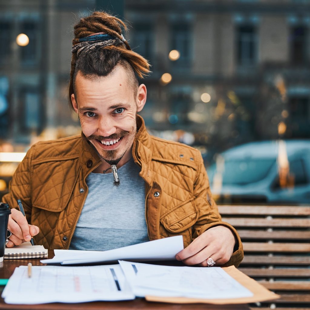cheerful hipster with sketchbook in urban cafe 6yzvmkw.jpg