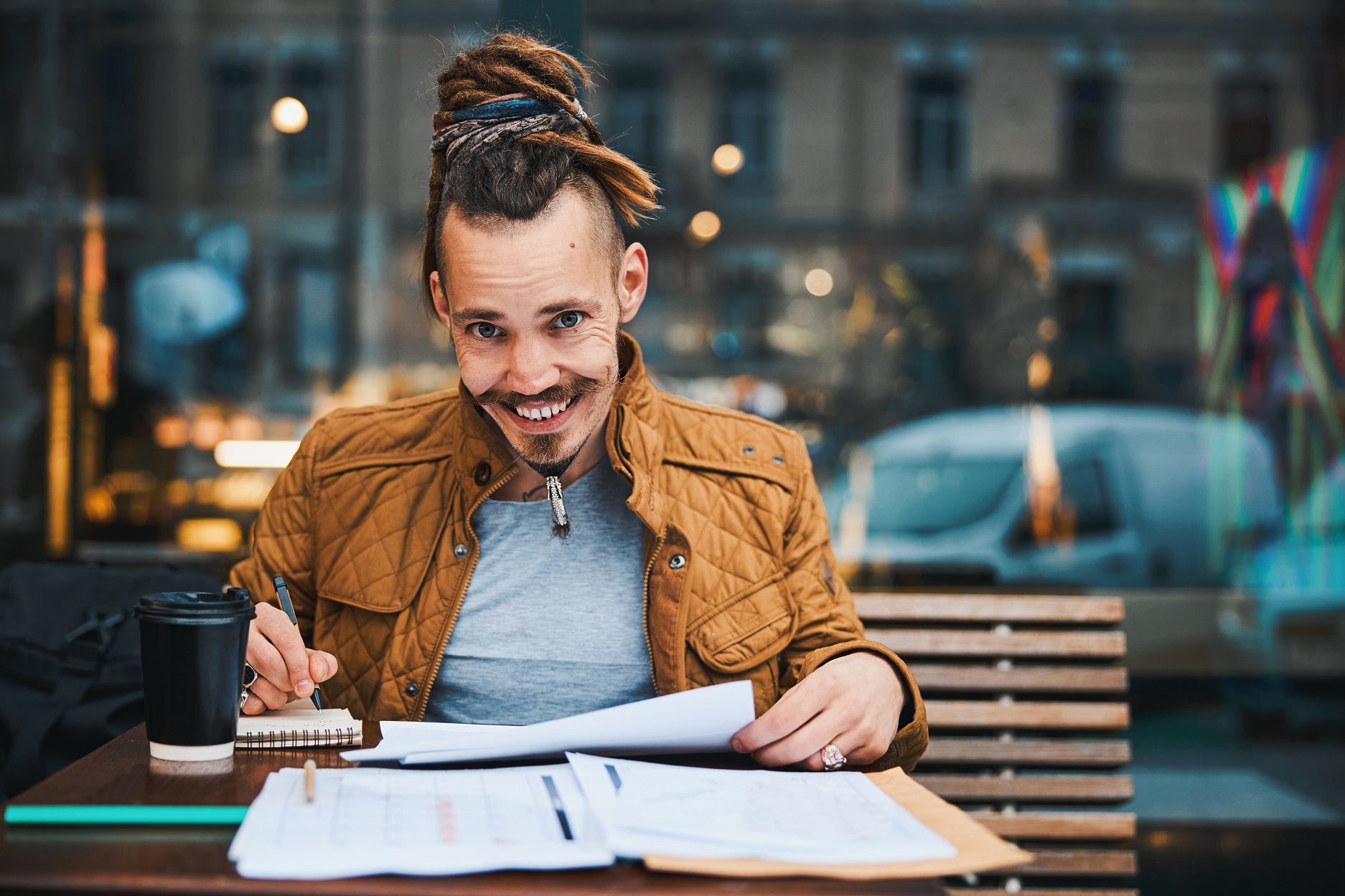cheerful hipster with sketchbook in urban cafe 6yzvmkw.jpg