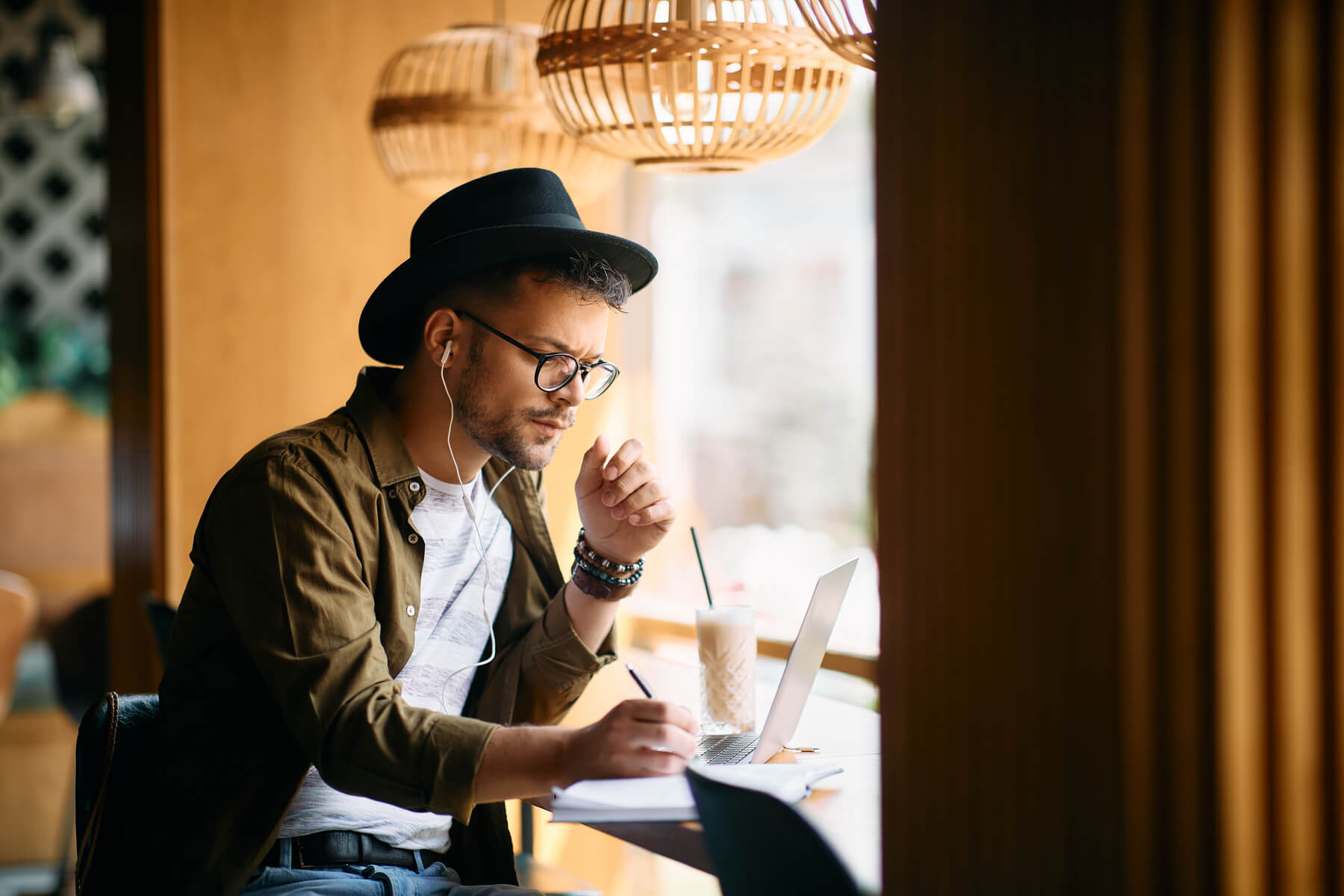 young man writing in notebook while using laptop a 2023 11 27 05 30 02 utc.jpg